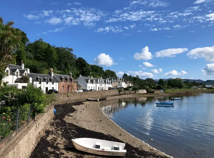 Scottish Harbours and Seaside Towns - view of Plockton, rowing boat in foreground and houses in background.