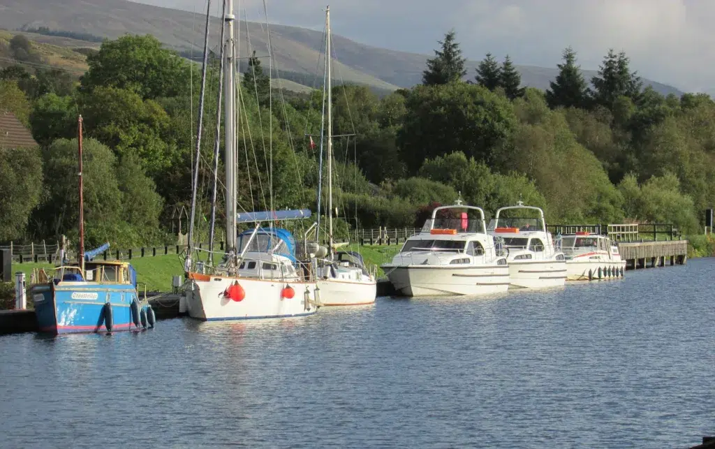 River with boats on the river. Caledonian canal in Scotland.