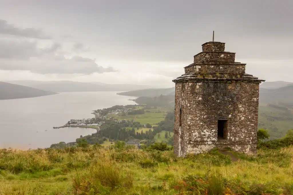 Dun Na Cuaiche monumnet on a hill. Loch in the background.